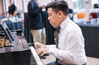 a young man playing a piano